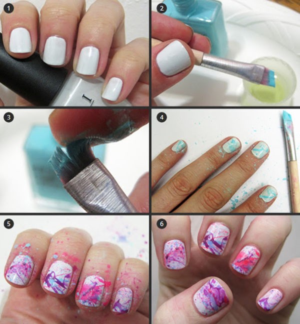 white nails with pink and purple splatter designs 