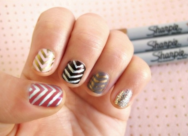 different colored nails with zig-zags drawn on by sharpies 