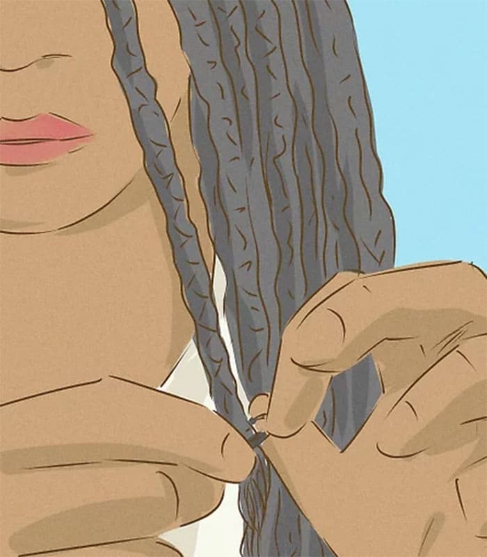 woman braiding the ends of her hair