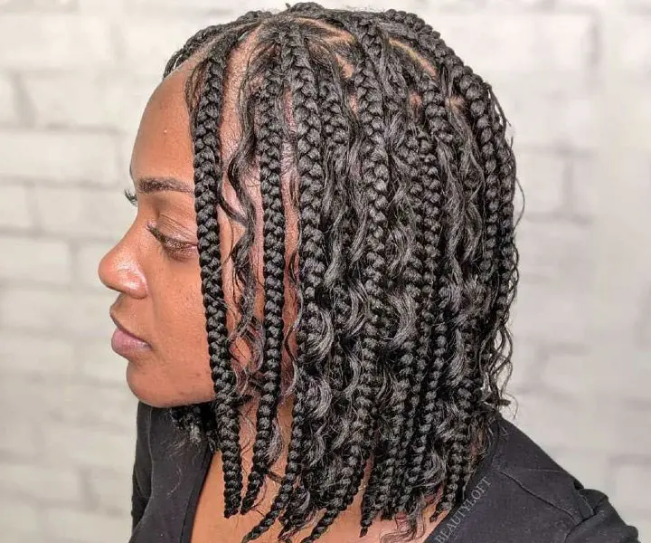 woman with short ghana braids and curls