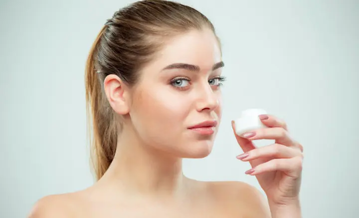 woman holding moisturizer