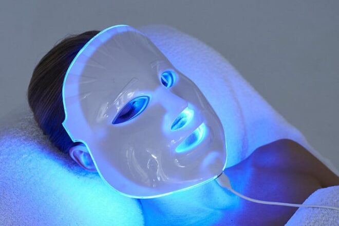 woman wearing LED face mask