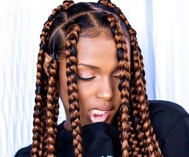 woman with copper jumbo box braids