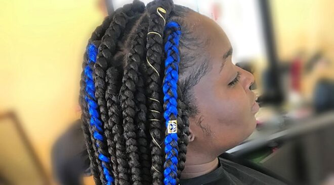 woman with jumbo box braids and blue streaks