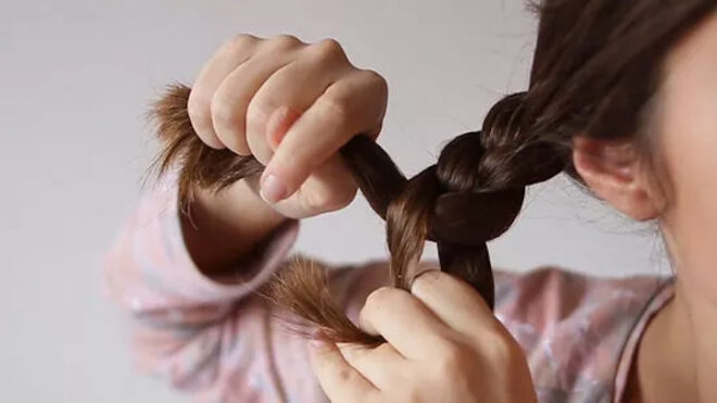 woman plaiting hair