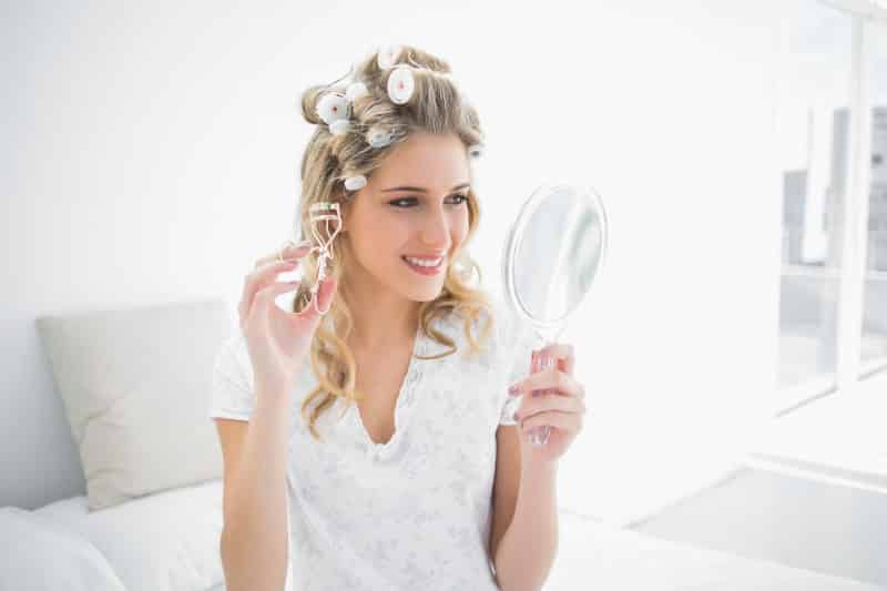 holding an eyelash curler